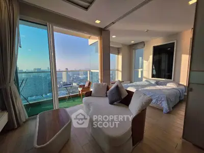 Luxurious bedroom with stunning city view and spacious balcony in modern high-rise apartment.