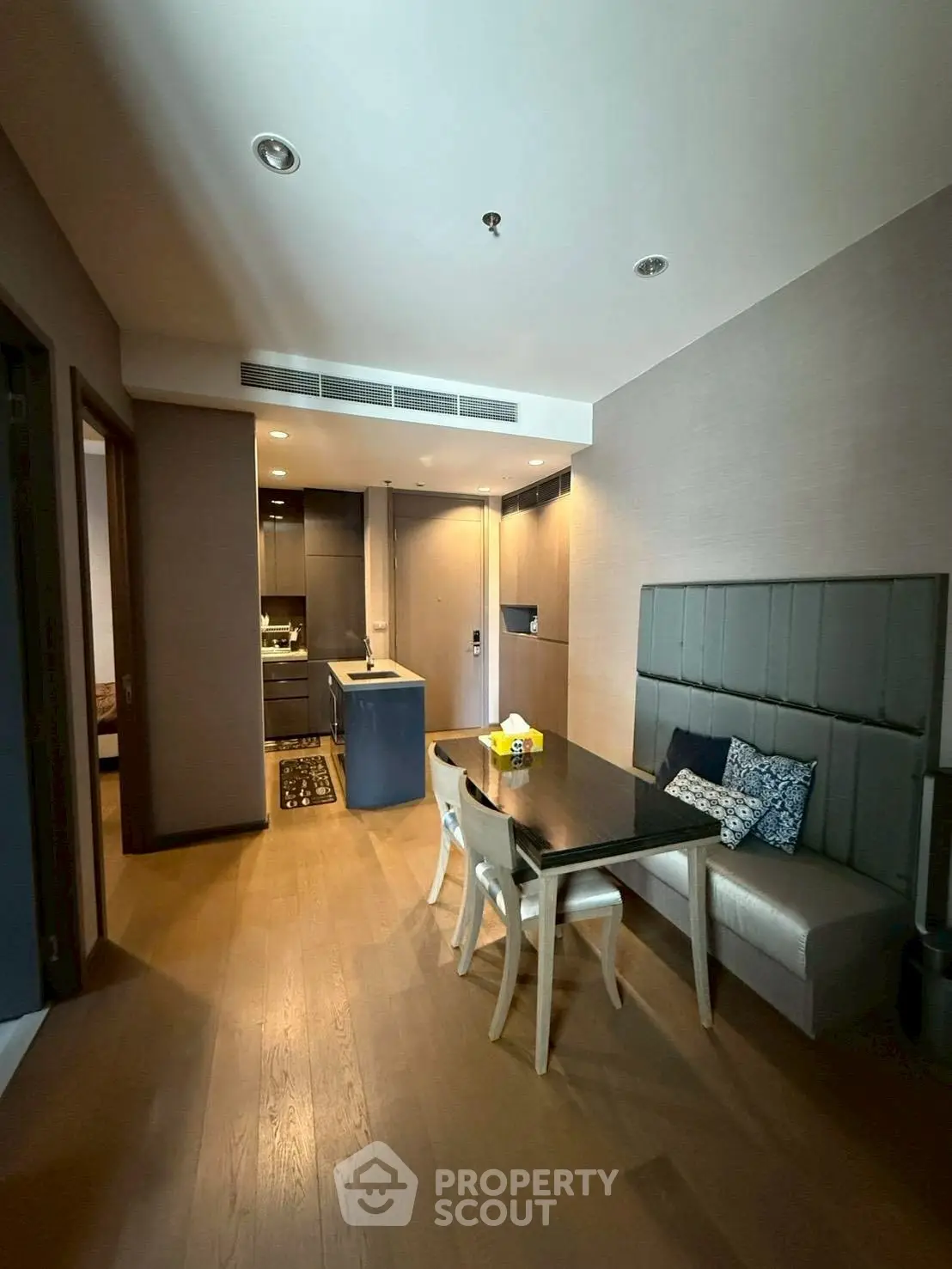 Modern open-plan kitchen and dining area with stylish decor and wooden flooring.