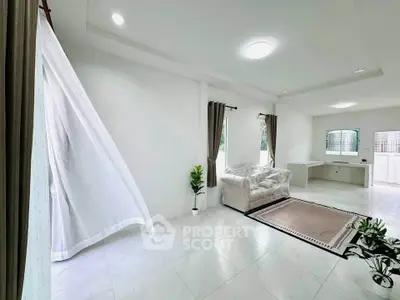 Spacious and bright living room with modern decor and large windows.
