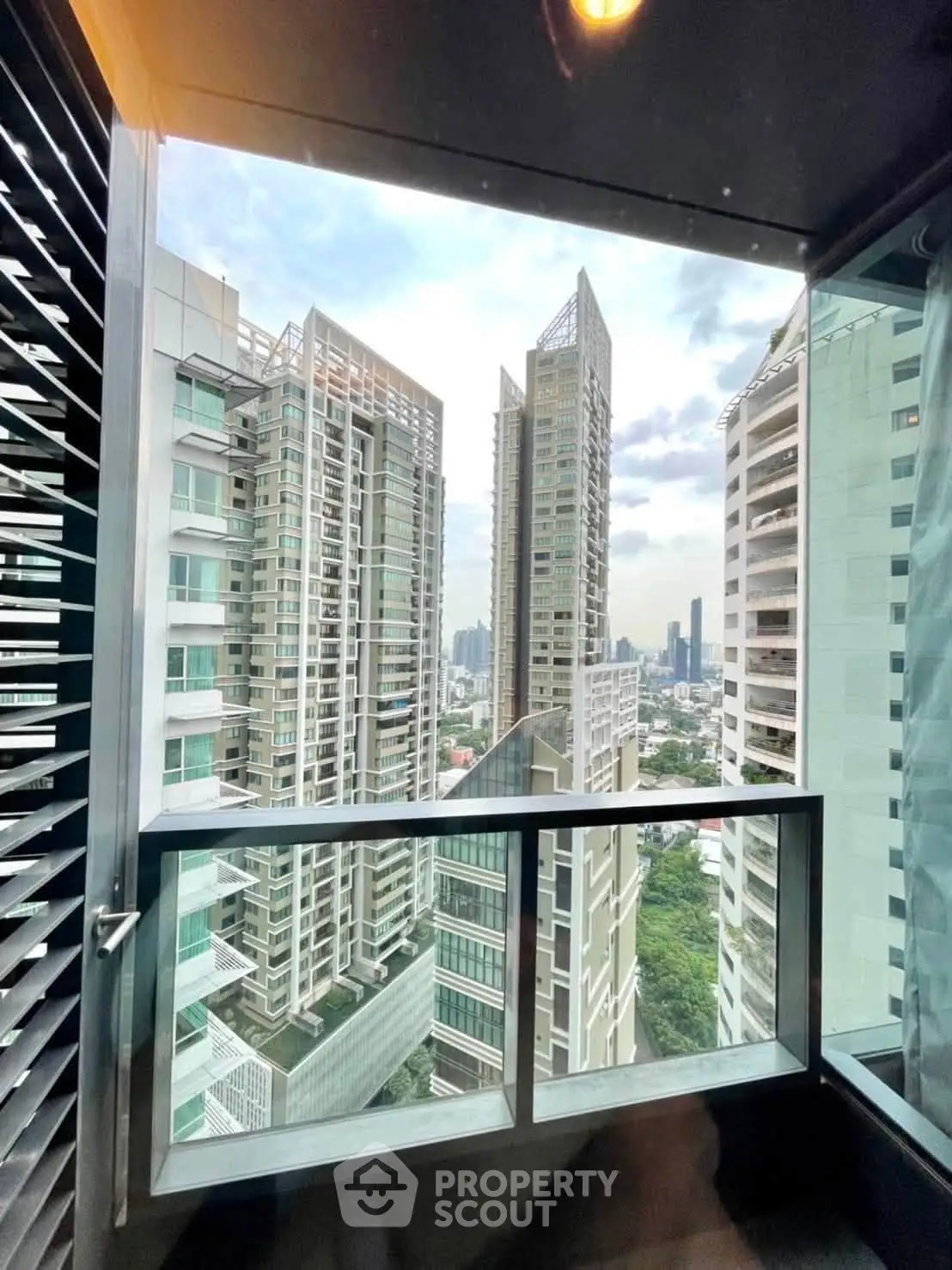 Stunning high-rise balcony view showcasing modern cityscape and architectural elegance.