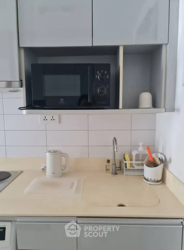 Modern kitchen with microwave and sleek cabinetry