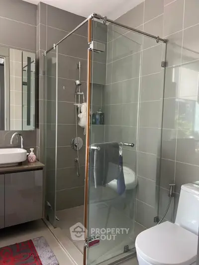Modern bathroom with glass shower enclosure and sleek fixtures