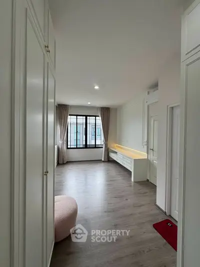 Spacious modern living room with elegant flooring and large windows