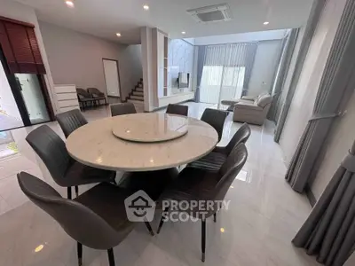 Spacious modern living room with elegant dining area and marble table