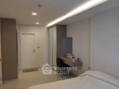Modern bedroom with sleek design and built-in wardrobe, perfect for urban living.