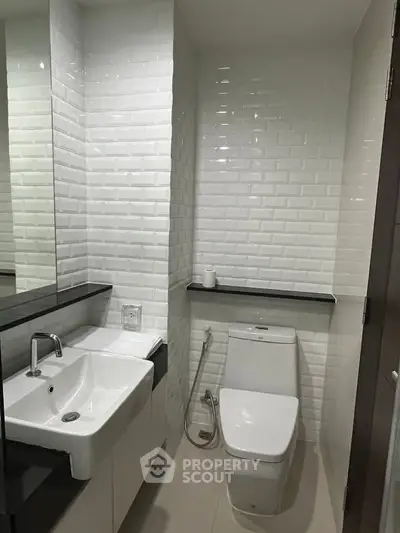 Modern bathroom with sleek white tiles and contemporary fixtures