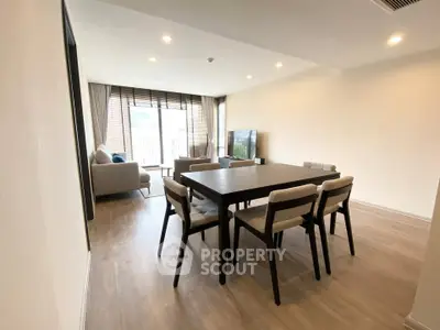 Spacious modern living room with dining area and large windows