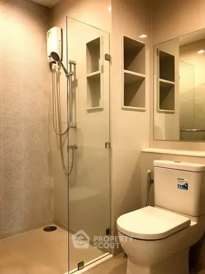 Modern bathroom with glass shower enclosure and sleek fixtures