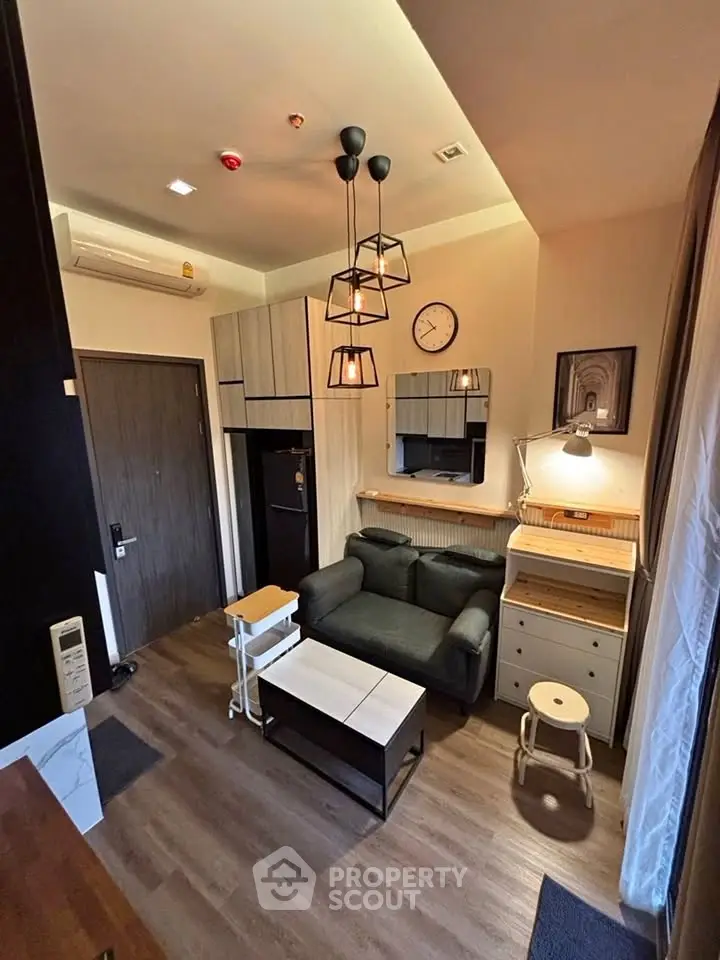 Modern living room with stylish furniture and elegant lighting in a cozy apartment.