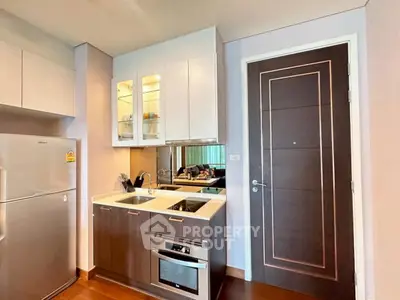 Modern kitchen with sleek cabinetry and built-in appliances in a stylish apartment.