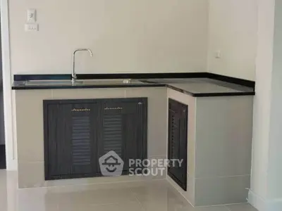 Modern kitchen with sleek black countertops and minimalist design