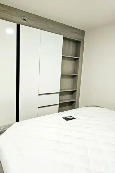 Modern bedroom with sleek built-in wardrobe and cozy bed