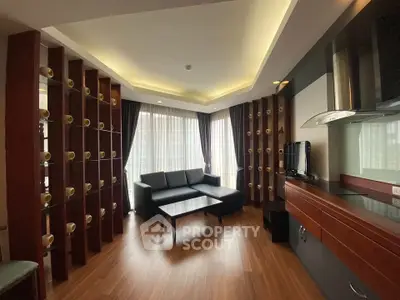 Modern living room with stylish decor and ample natural light, featuring a cozy sofa and elegant wooden flooring.