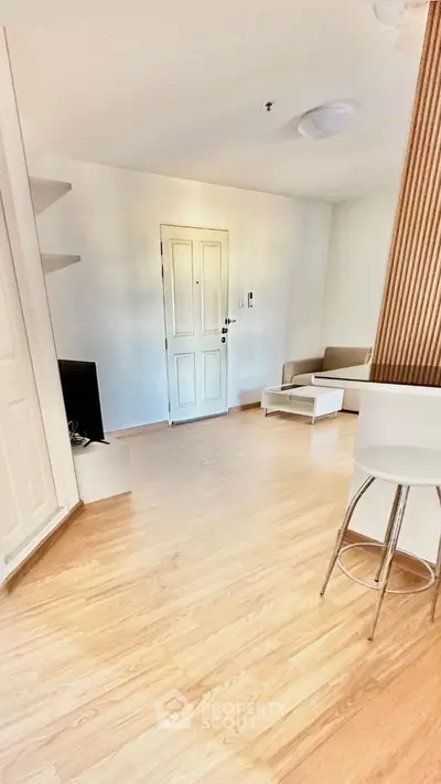 Modern living room with light wood flooring and minimalist furniture