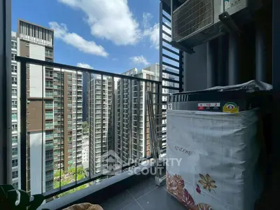 Modern balcony with city view and air conditioning unit in high-rise apartment.