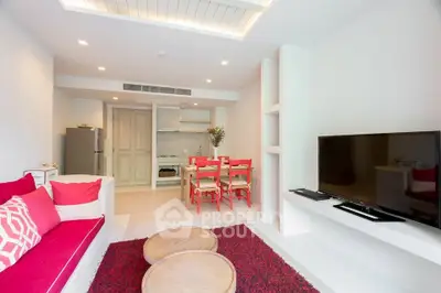 Modern living room with open kitchen, vibrant red accents, and sleek design in a cozy apartment.