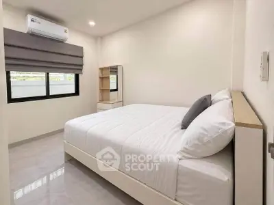 Modern minimalist bedroom with sleek design and ample natural light