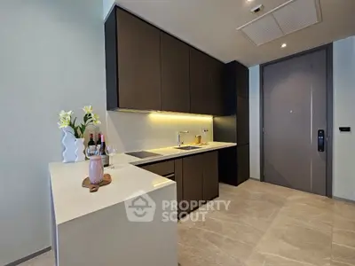 Modern kitchen with sleek cabinetry and elegant countertop in a stylish apartment.