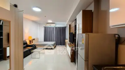 Modern studio apartment with open layout, featuring a cozy living area and sleek kitchen.