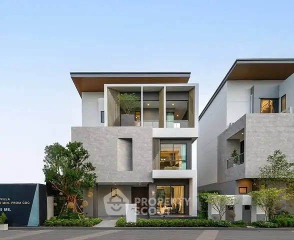 Modern three-story villa with sleek design and large windows in a serene neighborhood.