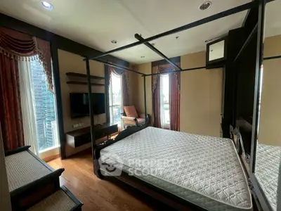 Luxurious bedroom with elegant decor and city view, featuring a stylish four-poster bed and modern amenities.