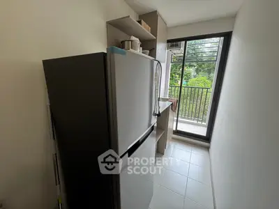 Modern kitchen with stainless steel fridge and balcony view