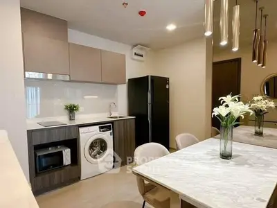 Modern kitchen with sleek appliances and elegant dining area