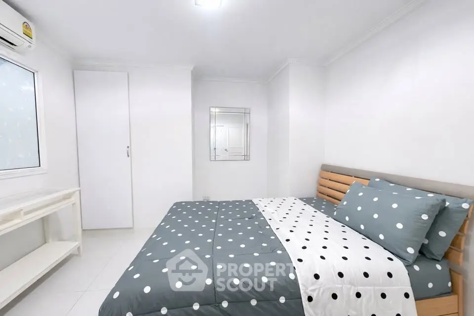 Modern bedroom with polka dot bedding and minimalist decor