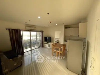 Bright and airy living room with modern kitchen and balcony access