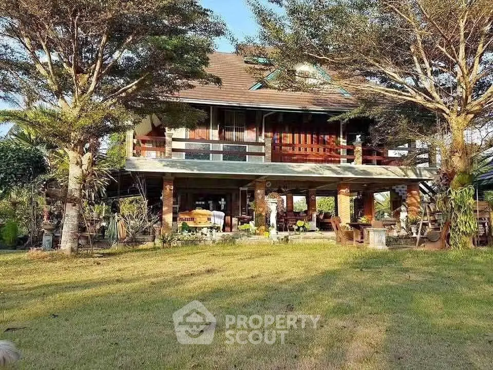Charming two-story house with spacious balcony and lush garden, perfect for serene living.
