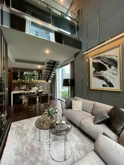 Luxurious modern living room with high ceilings and elegant decor in a stylish apartment.
