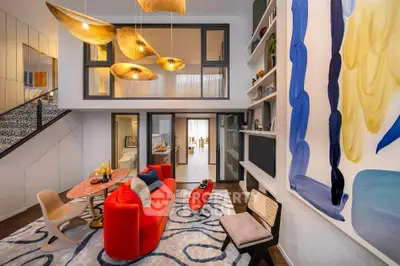 Luxurious modern living room with vibrant decor and unique lighting fixtures.