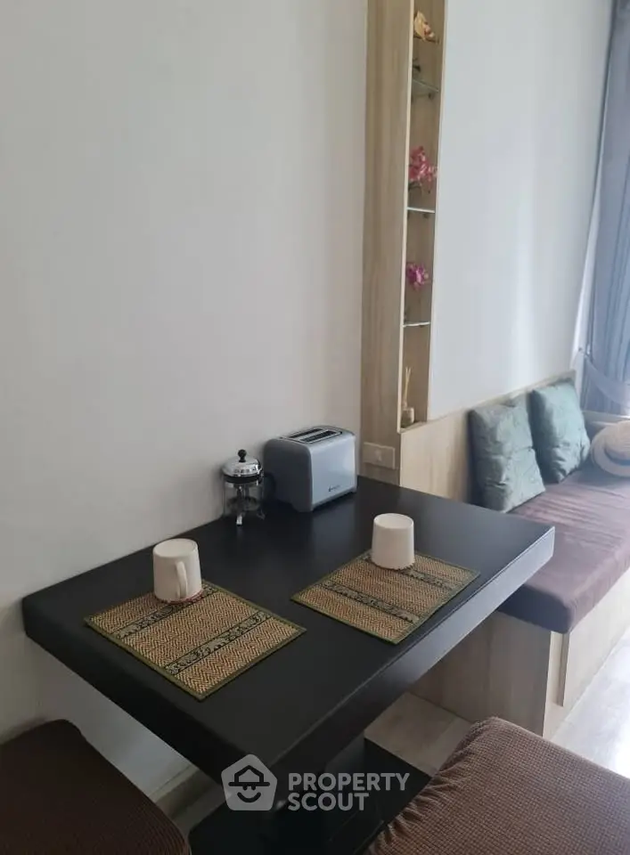 Cozy dining nook with modern table and built-in seating in stylish apartment.