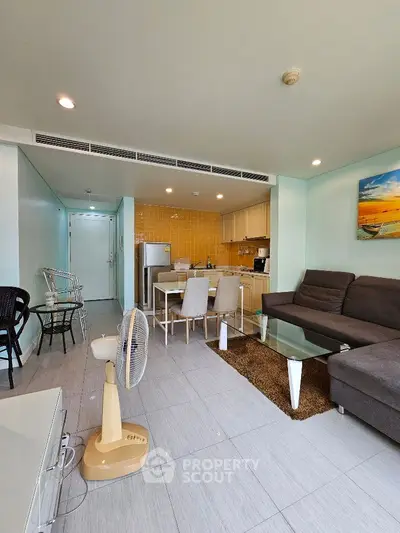 Spacious open-layout living room with modern kitchen and stylish decor