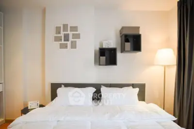Cozy bedroom with modern decor and soft lighting, perfect for relaxation.