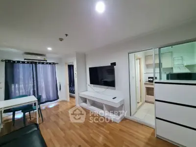 Modern apartment living room with hardwood floors and wall-mounted TV