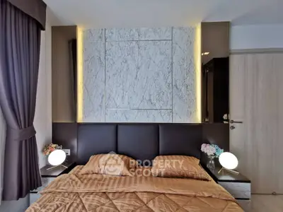 Luxurious bedroom with elegant marble accent wall and modern lighting