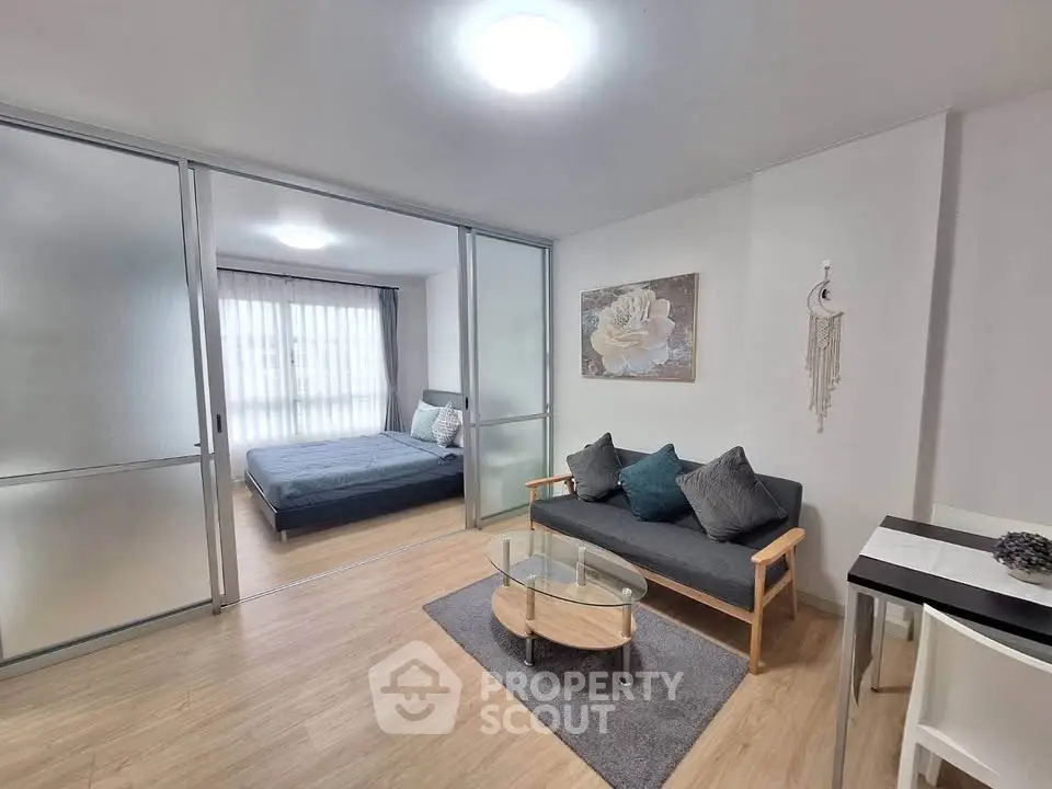 Modern studio apartment with sliding glass doors and cozy living area.