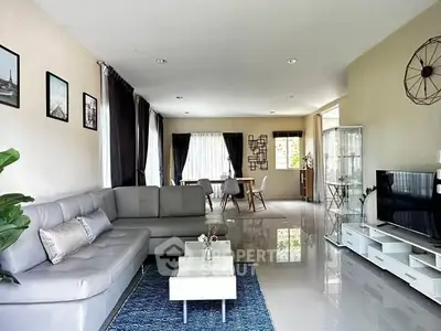 Spacious modern living room with sleek furniture and abundant natural light.