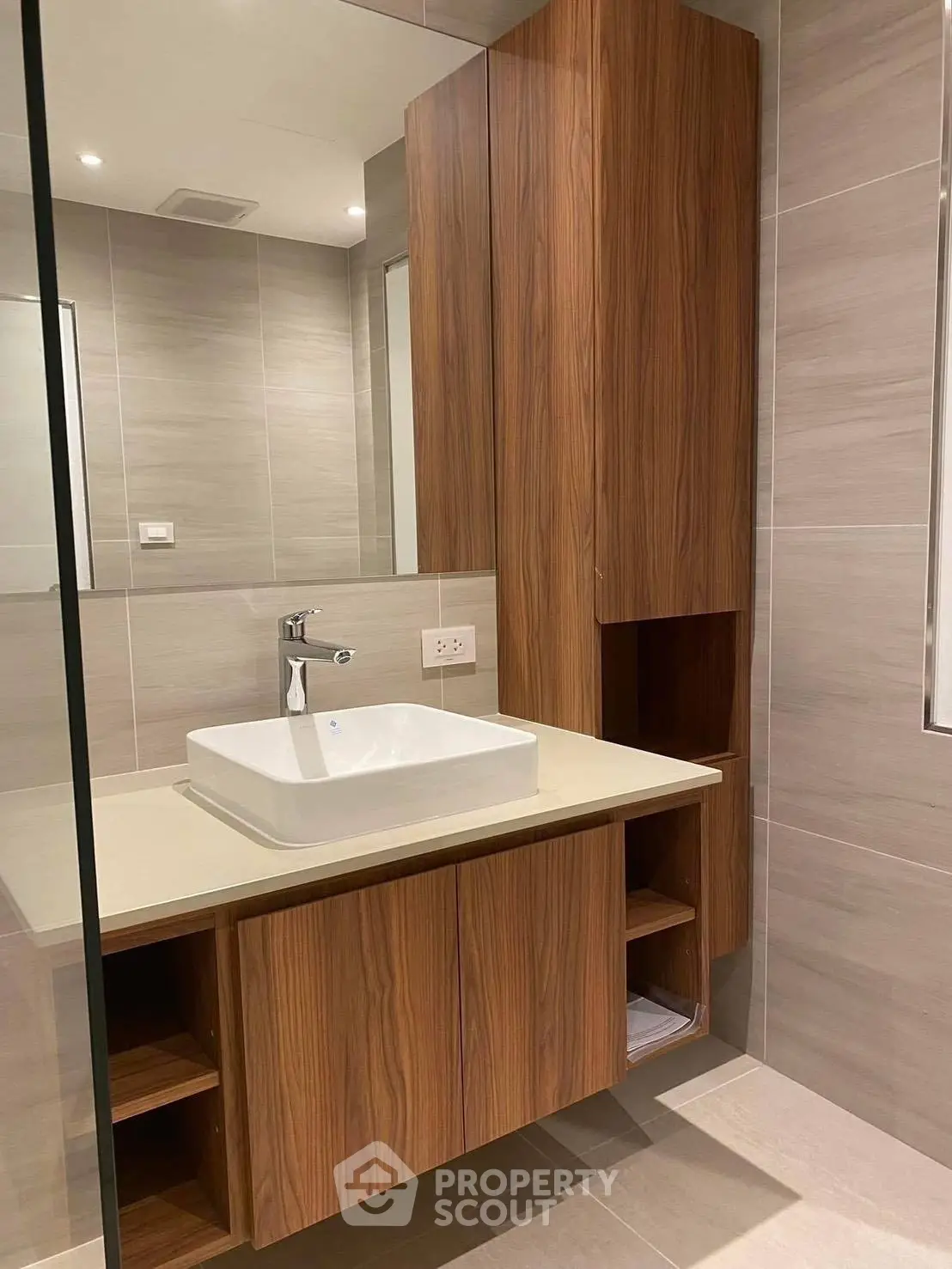 Modern bathroom with sleek wooden cabinetry and elegant sink design