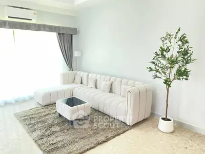 Spacious modern living room with elegant white sofa and stylish decor