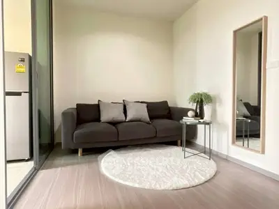 Cozy living room with modern sofa and stylish decor in a bright apartment.