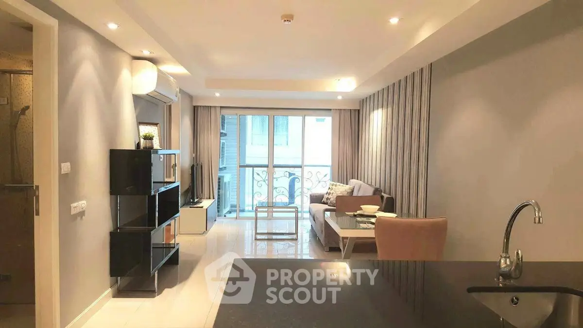 Spacious modern living room with open layout and balcony access, perfect for urban living.
