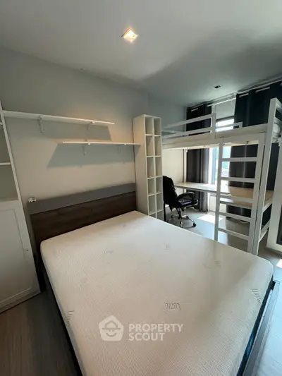 Modern bedroom with minimalist design featuring a double bed and workspace.