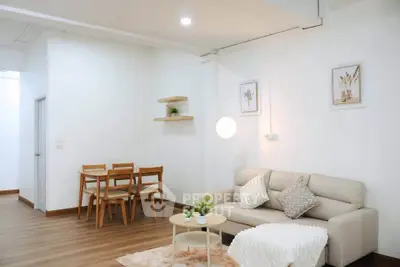 Modern living room with cozy sofa and dining area in minimalist style