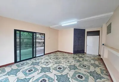 Spacious room with unique tiled flooring and sliding glass doors leading to outdoor area.