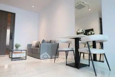 Modern living room with sleek furniture and elegant dining area, perfect for urban living.