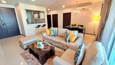 Spacious living room with modern decor and open kitchen layout