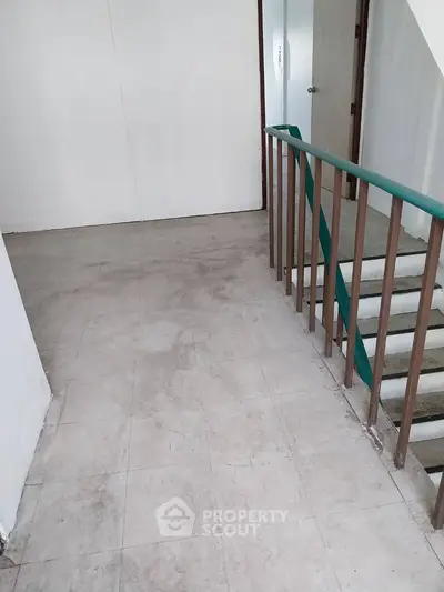 Spacious interior hallway with staircase and tiled flooring