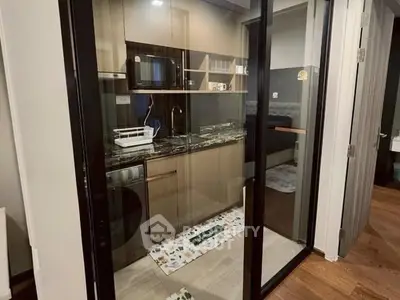 Modern compact kitchen with glass sliding doors and stylish cabinetry